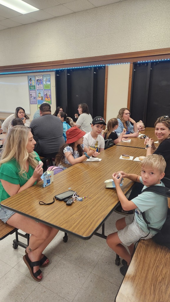 students and families enjoying donuts