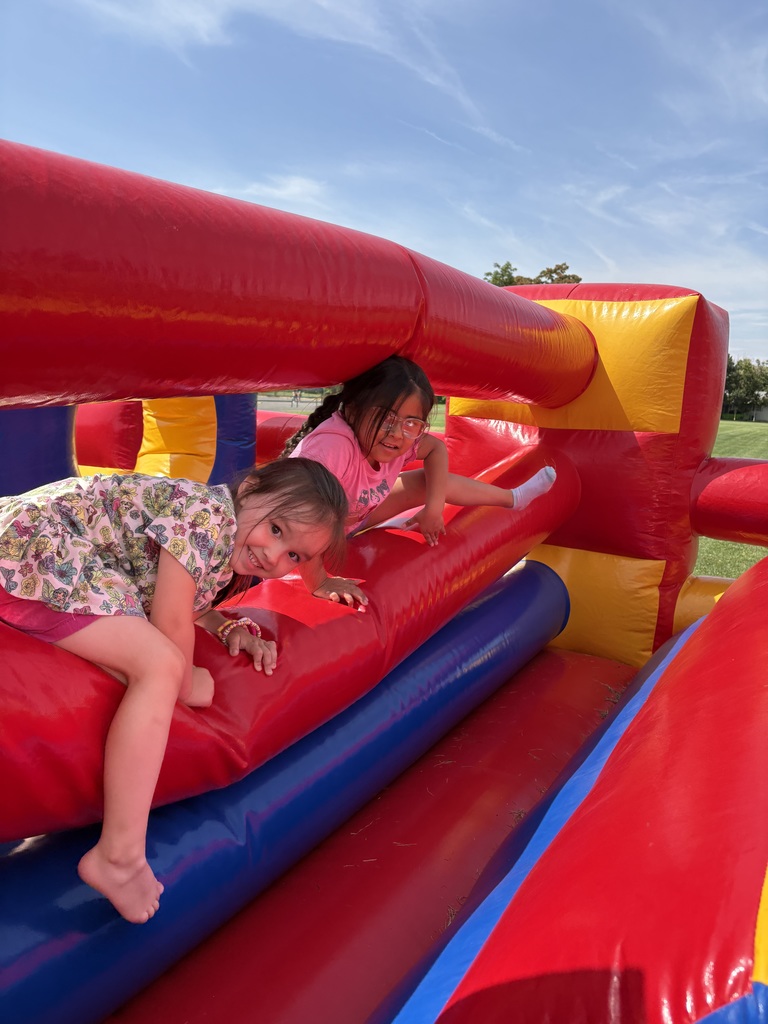 Students racing through the bouncy house obstacle course
