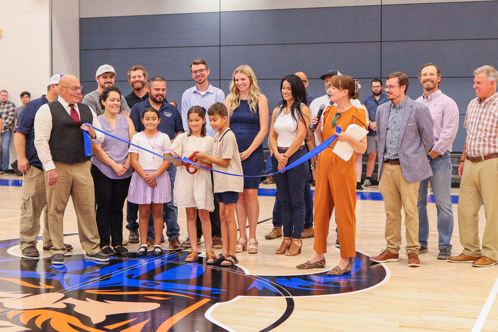 students cutting the ribbon at the CVI ceremony