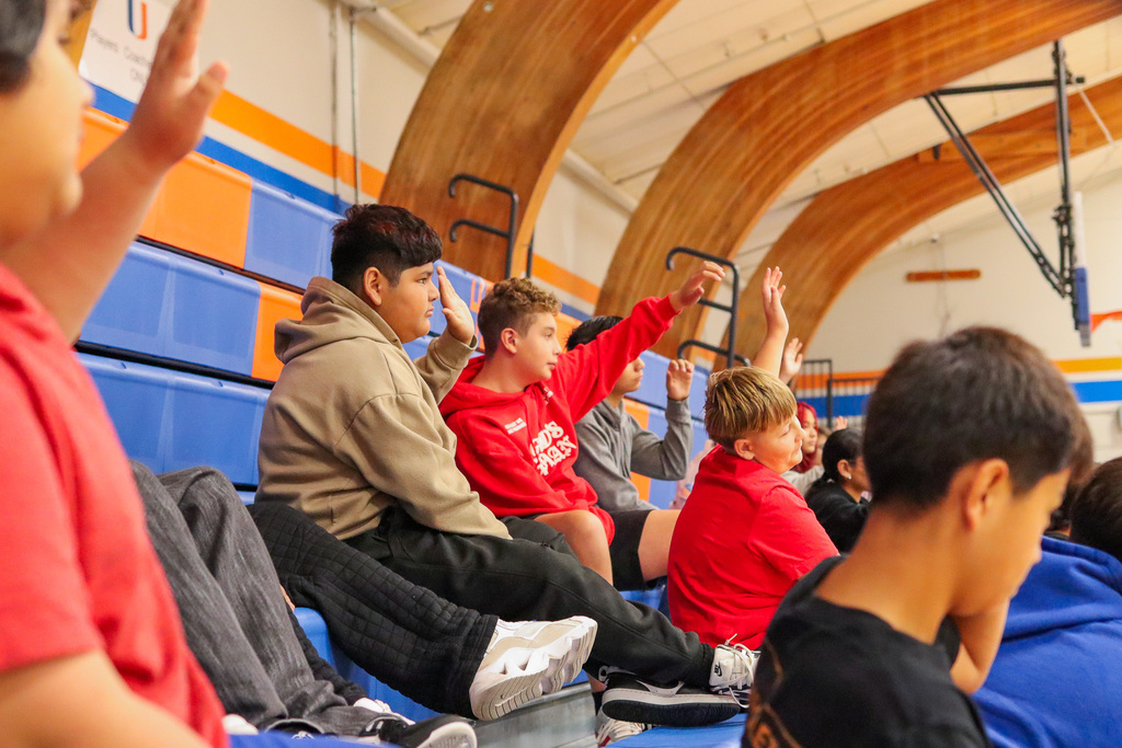 students raising hands