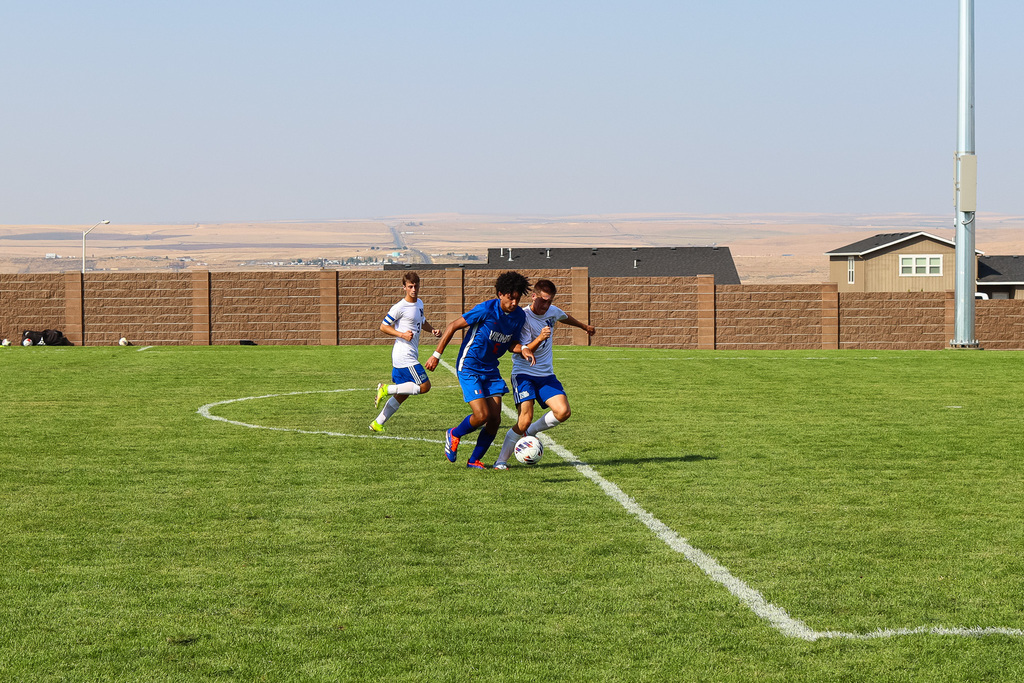 high school soccer athlete fighting for the ball