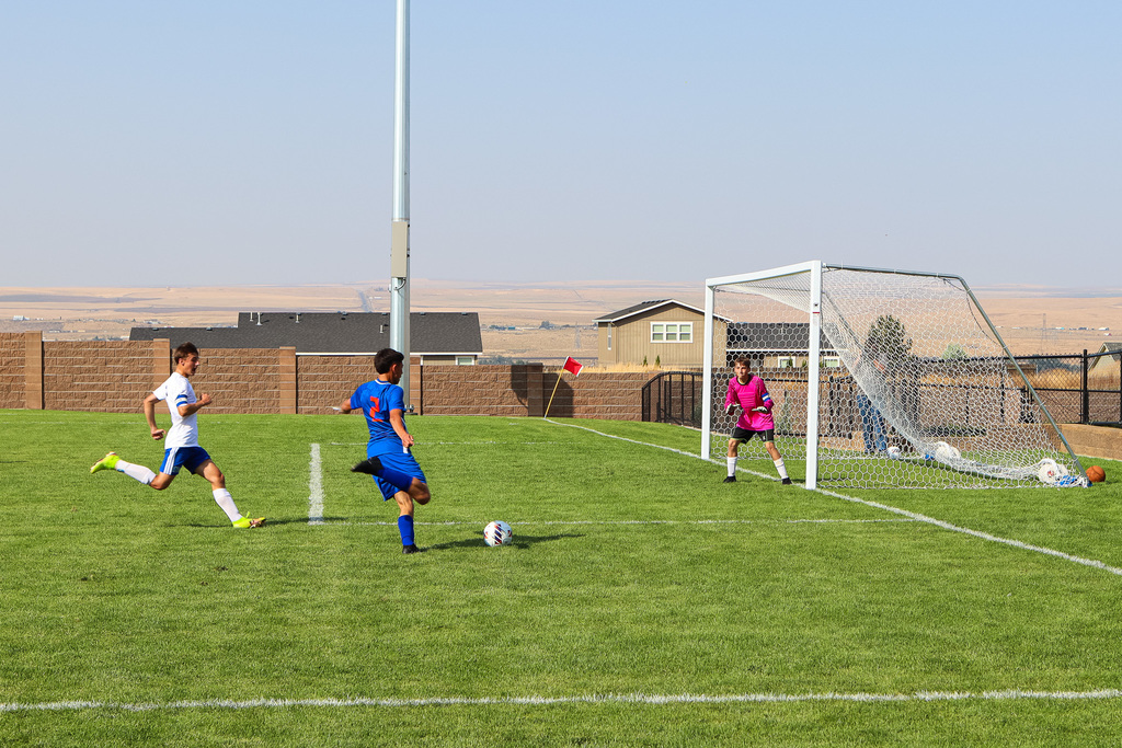 high school soccer player #2 kicking the ball towards goal