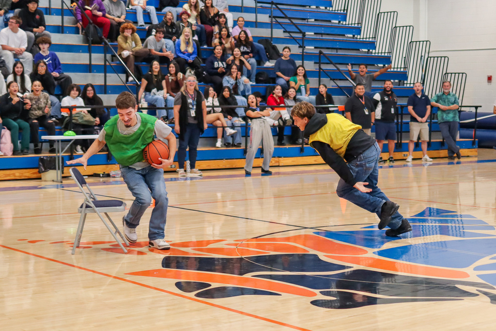 students playing basketball musical chairs