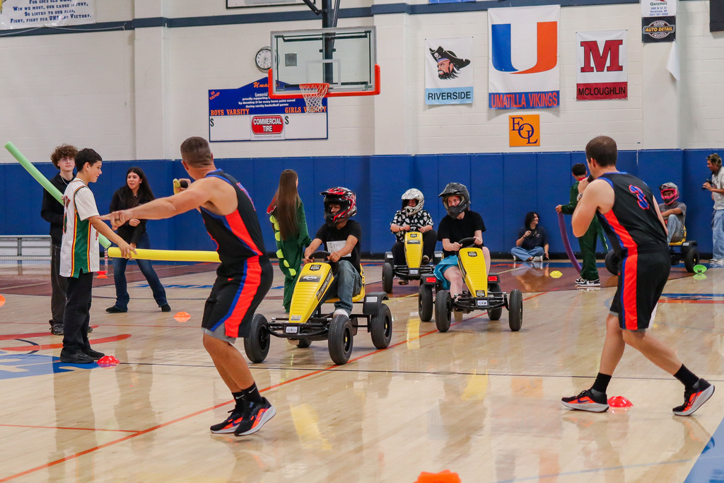 students and staff racing on pedal bikes