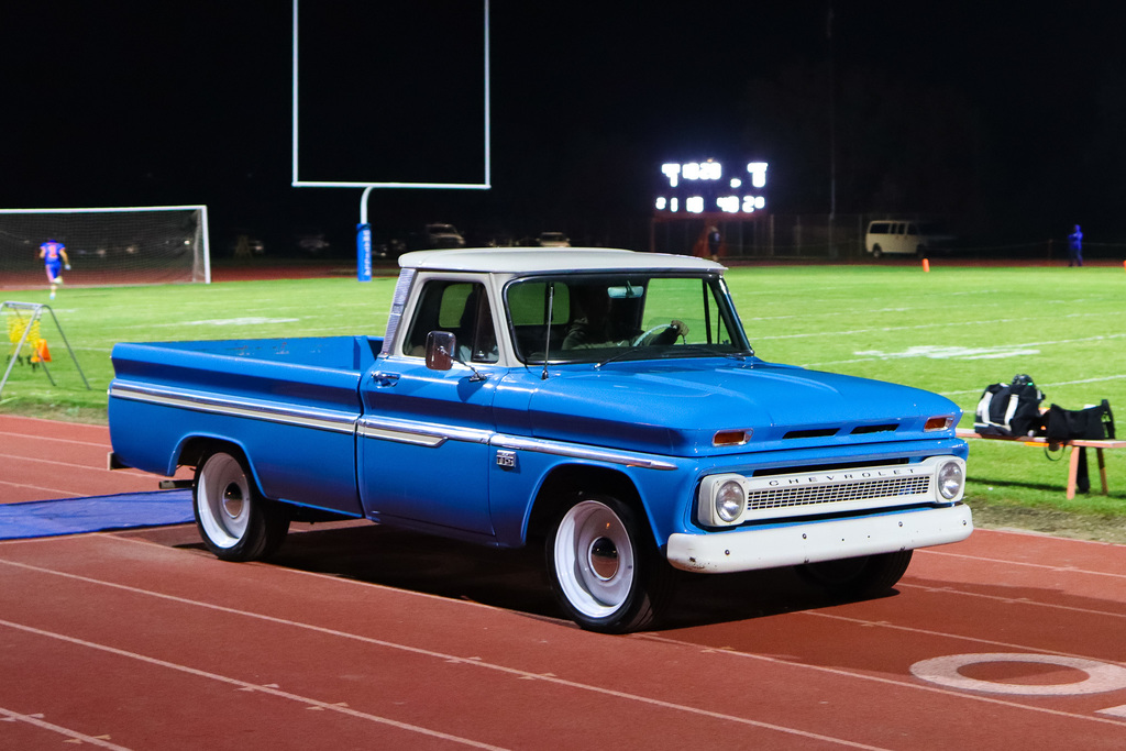 Photo of princess being drove on the field in a vintage car