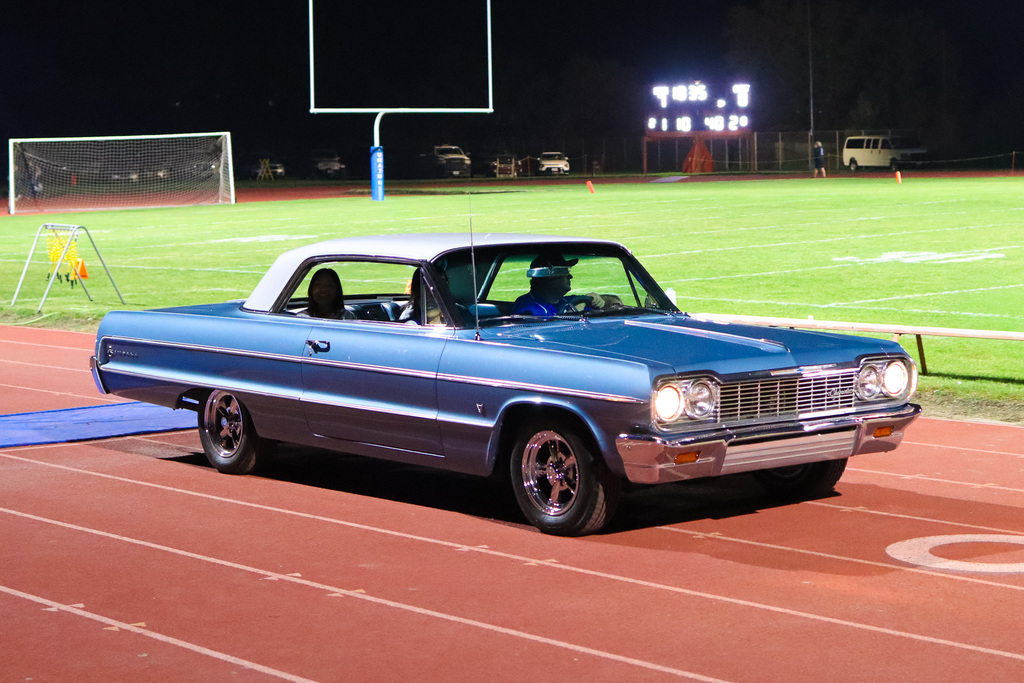Photo of princess being drove on the field in a vintage car