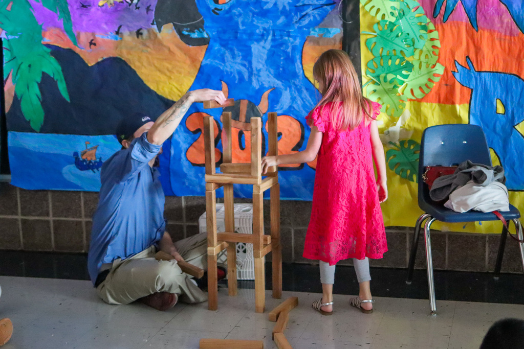 student with family stacking blocks