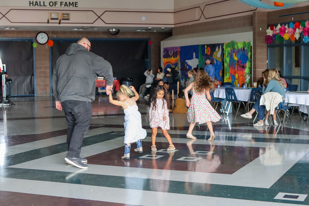 students with family dancing