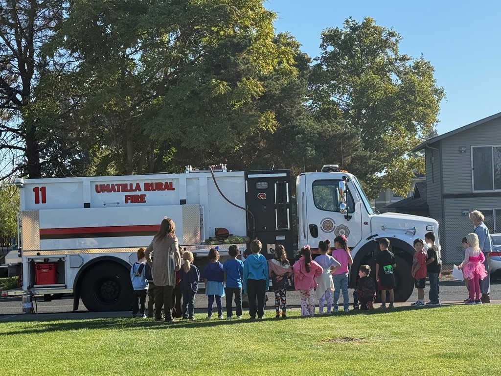 students listening to firefighter's presentation