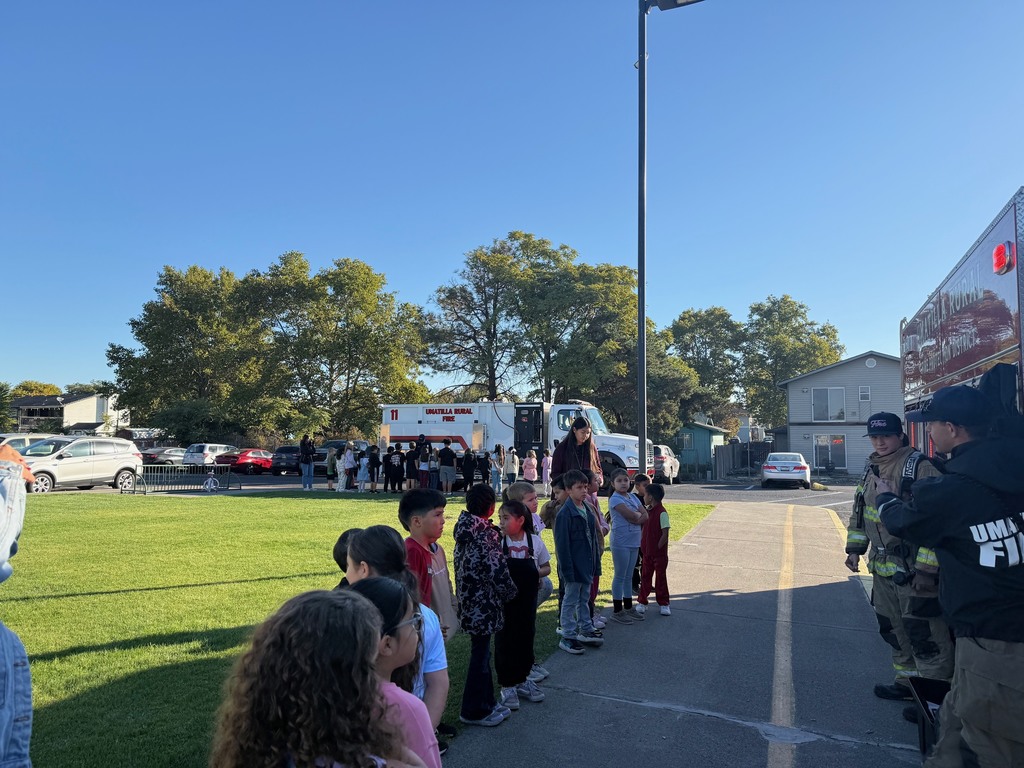 Students meeting with firefighters and learning about their gear