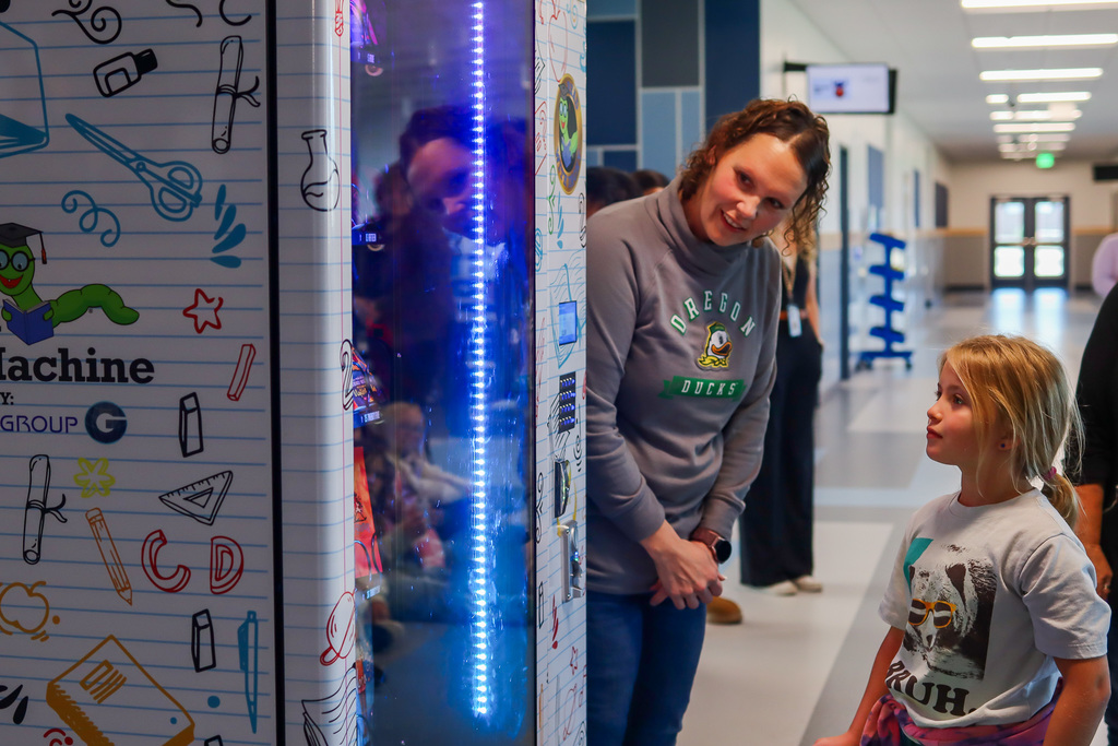 4th Grader Sophia choosing the first book from the machine