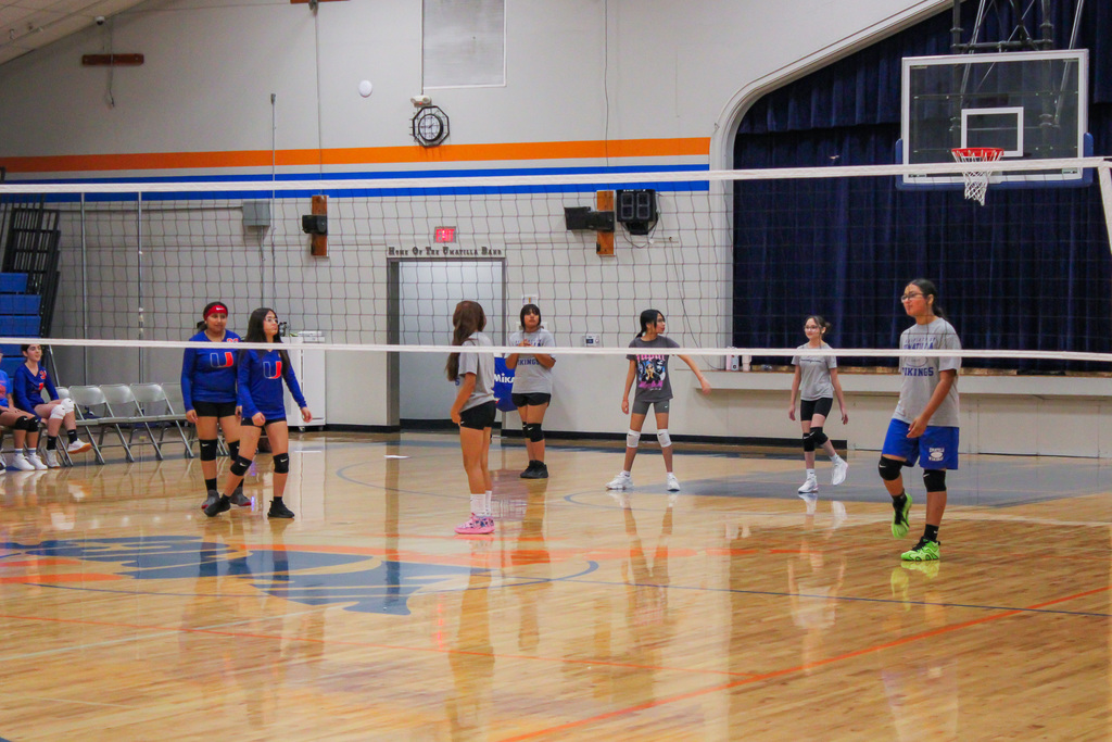 Volleyball players playing a game of volleyball against each other
