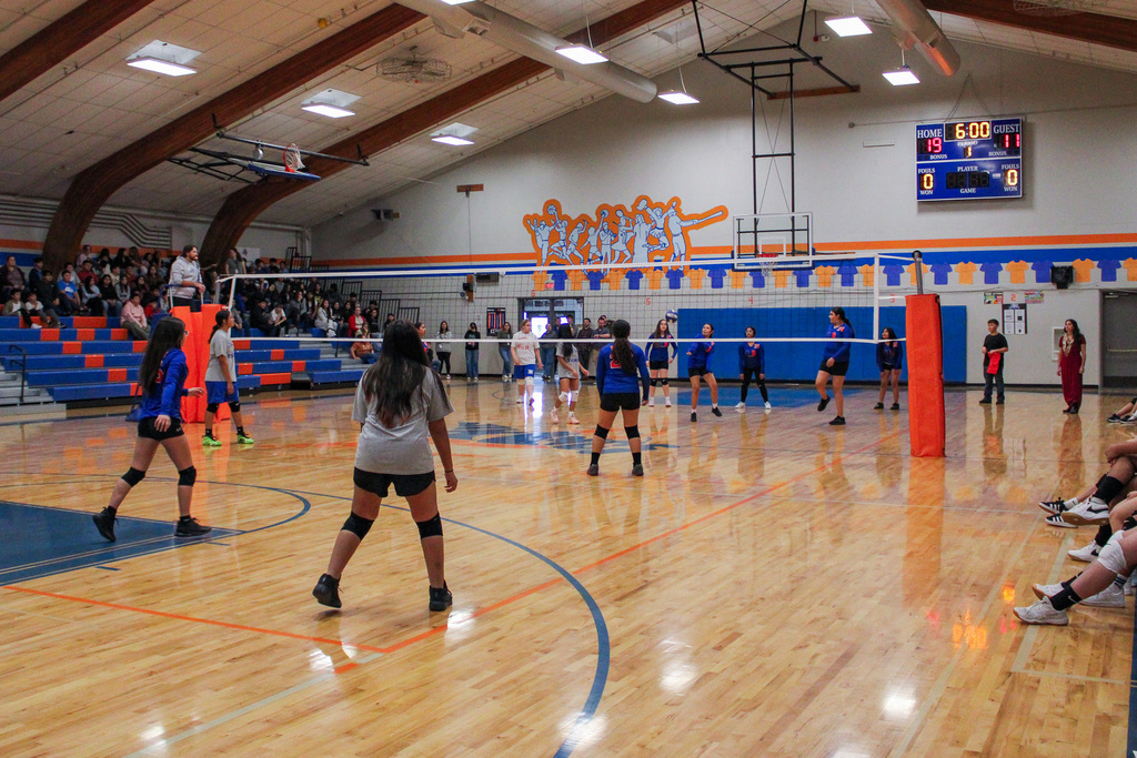 Volleyball players playing a game of volleyball against each other