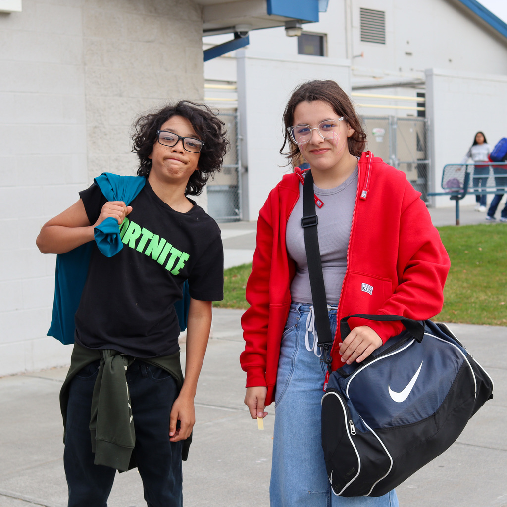Student with a pillow case and one with a duffle bag
