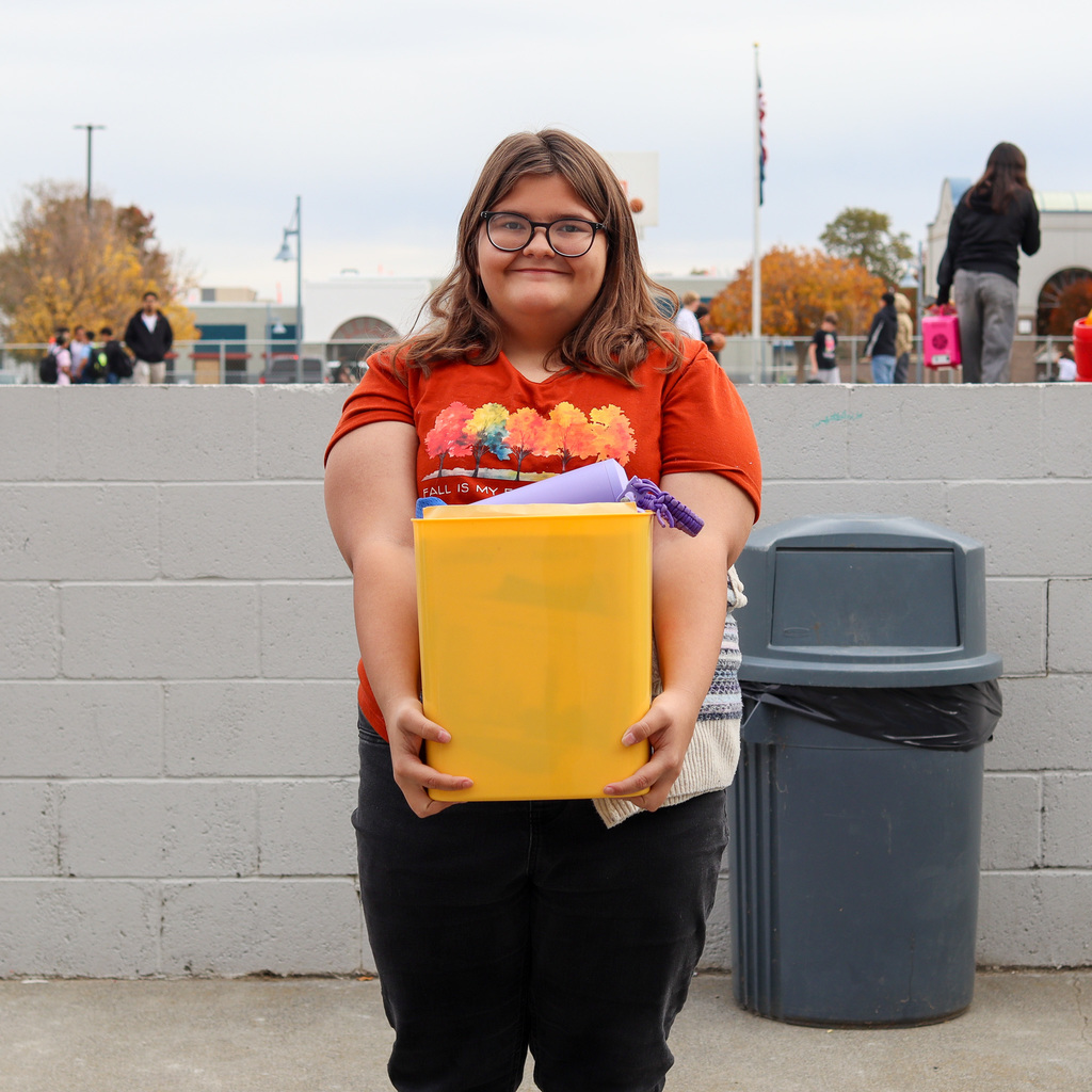 Student with a garbage can