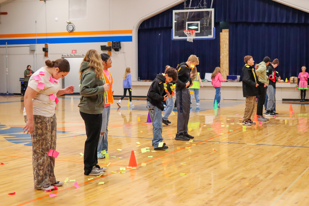 students participating in assembly game