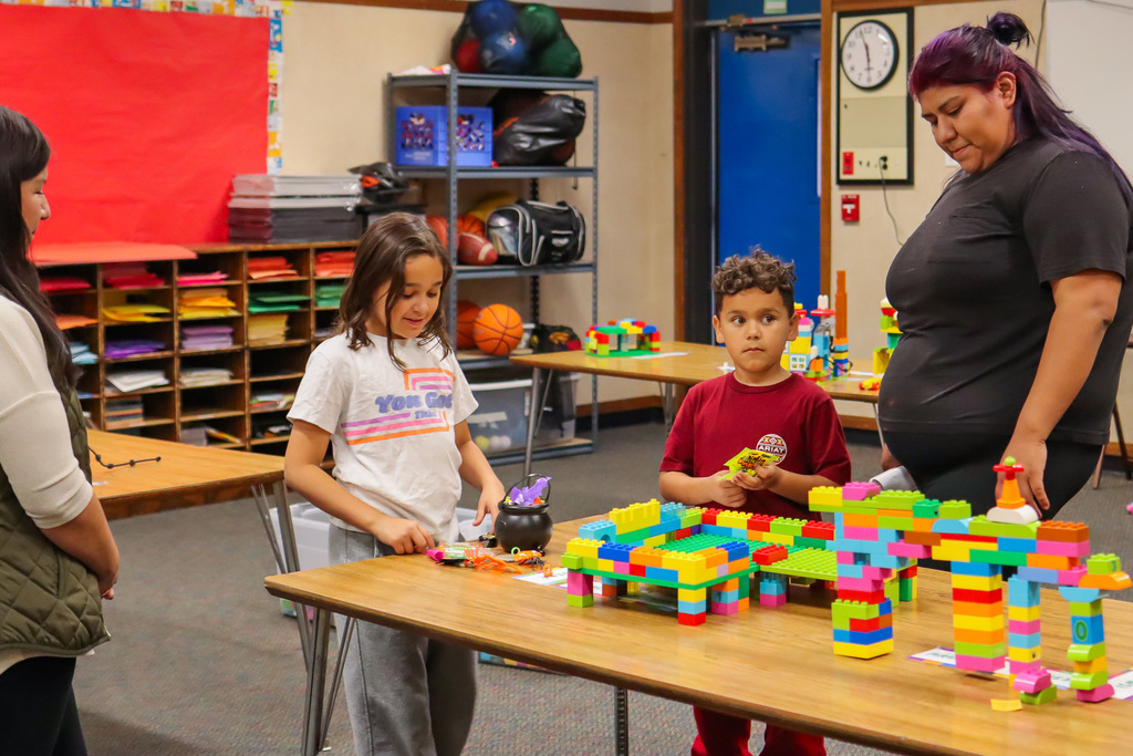 student showing family project made of legos