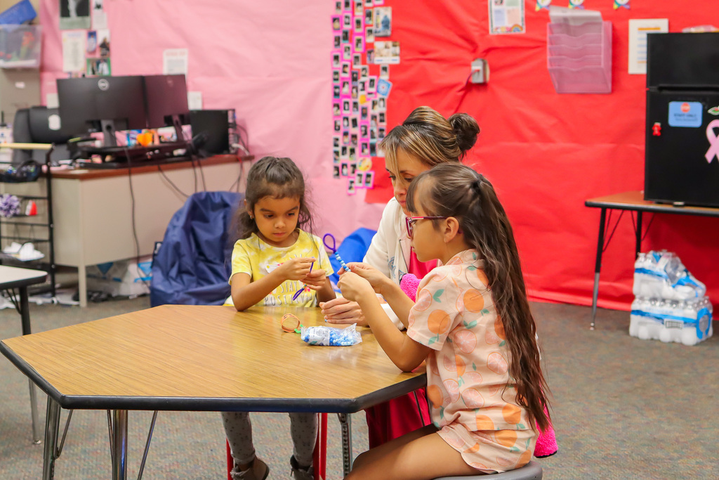 student and family working on a craft project