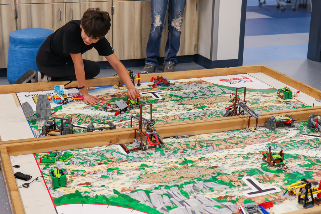 student working on lego robot