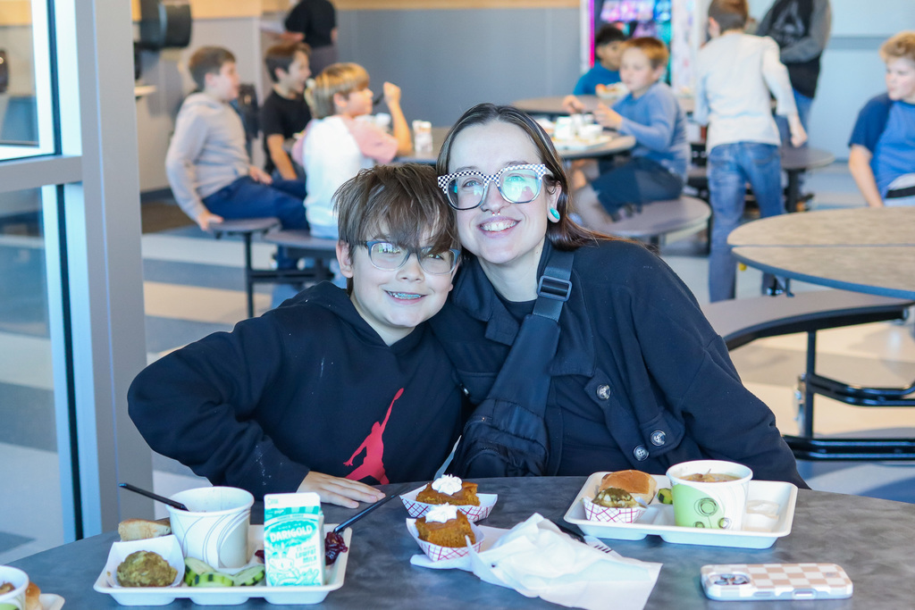 photo of student with family enjoy thanksgiving meal