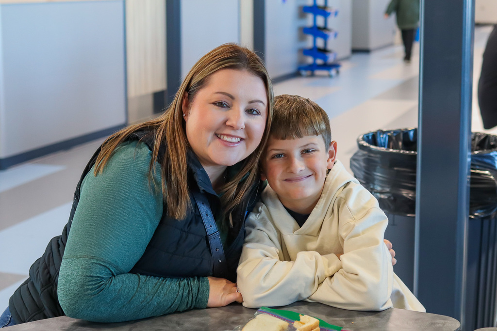 photo of student with family enjoy thanksgiving meal