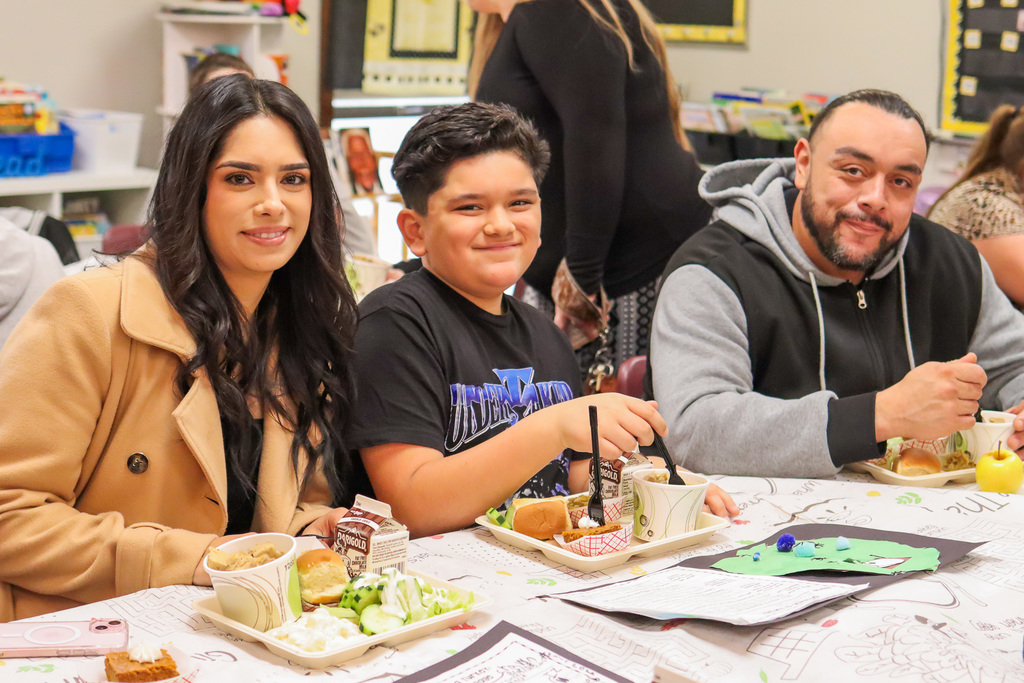 Photo of student with family at Thanksgiving Feast