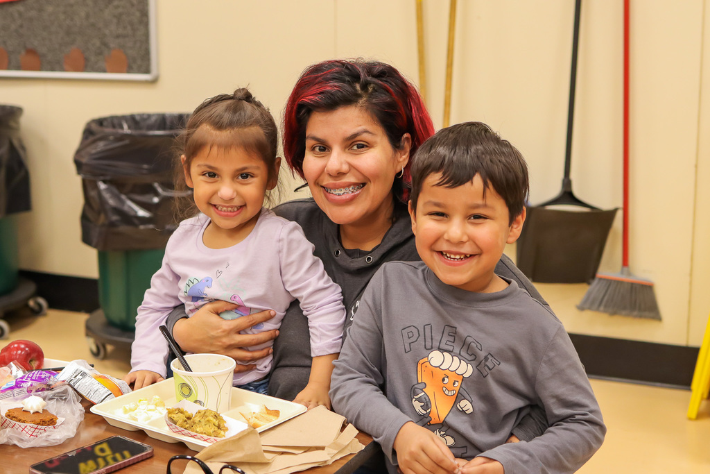 Photo of student with family at Thanksgiving Feast