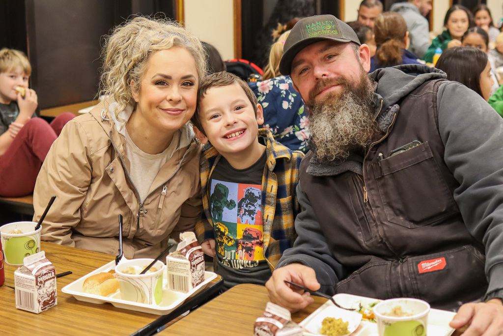 Photo of student with family at Thanksgiving Feast