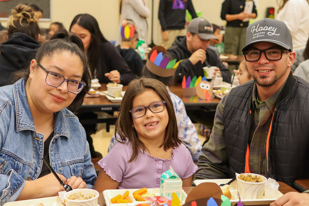 Photo of student with family at Thanksgiving Feast
