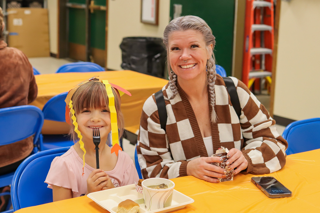 Photo of student with family at Thanksgiving Feast