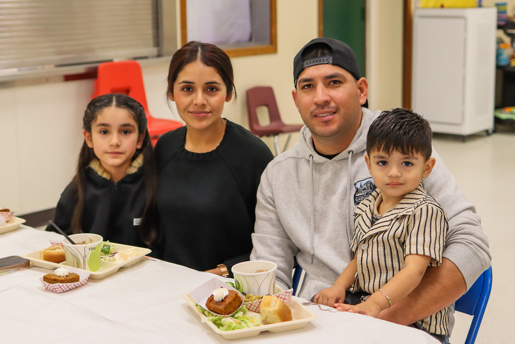 Photo of student with family at Thanksgiving Feast