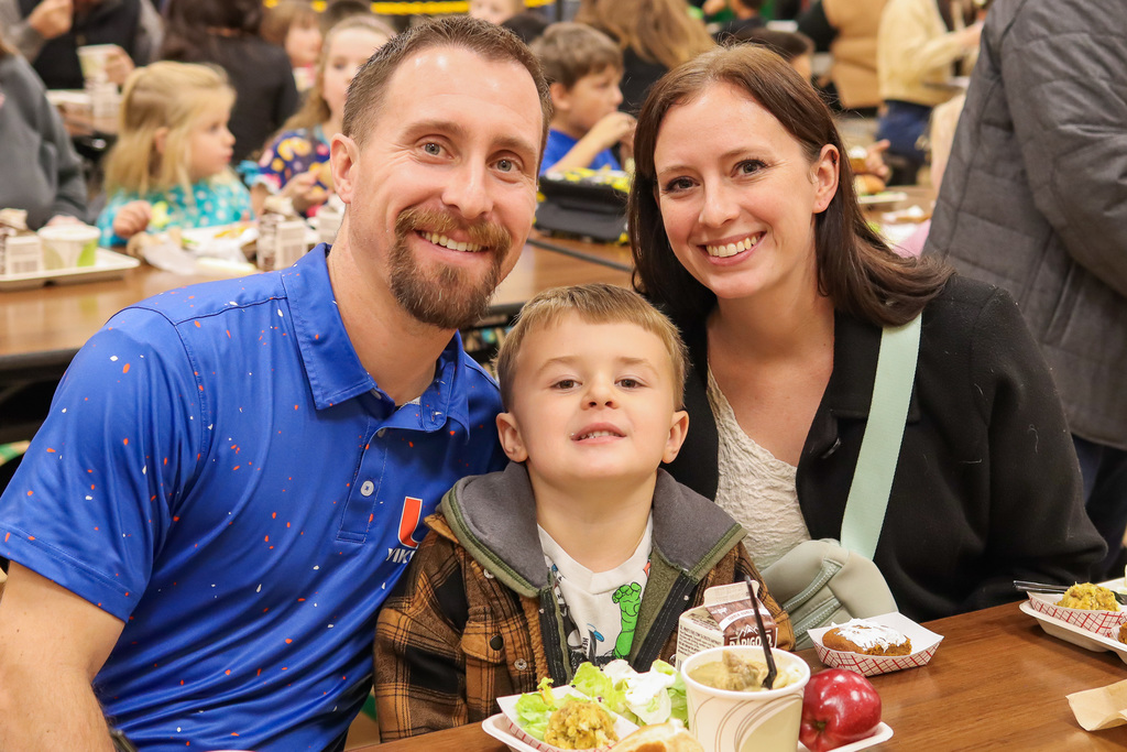 Photo of student with family at Thanksgiving Feast