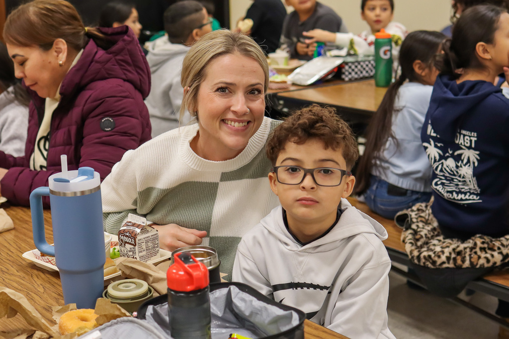 Photo of student with family at Thanksgiving Feast