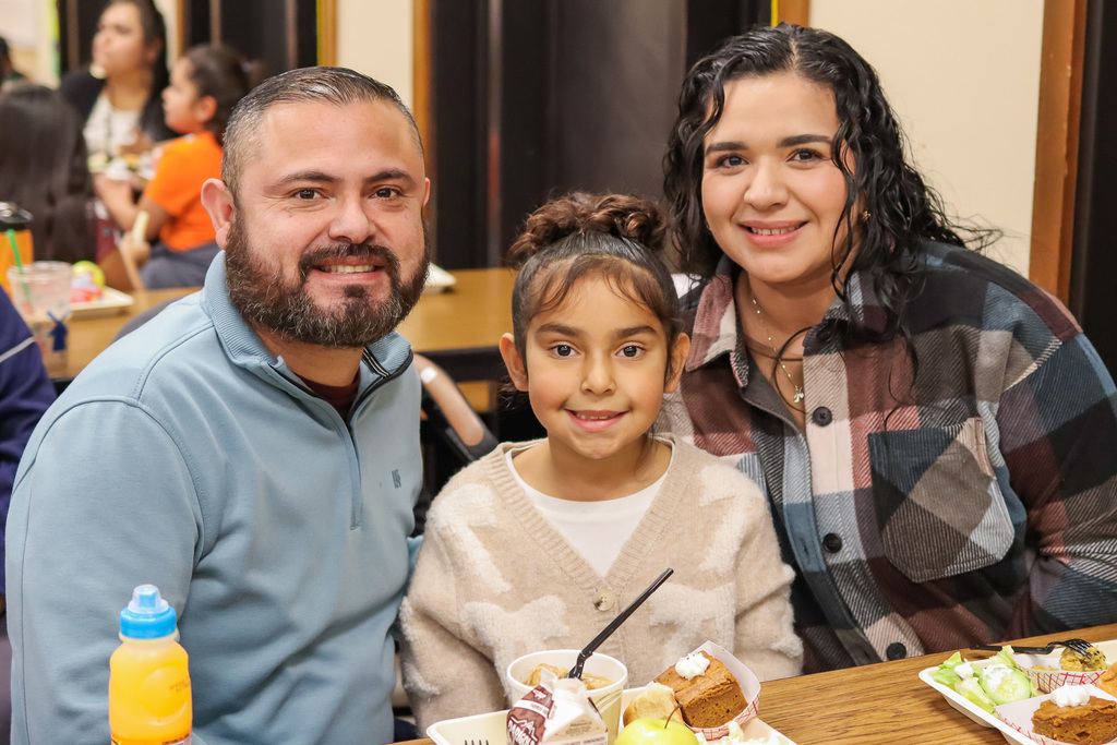 Photo of student with family at Thanksgiving Feast