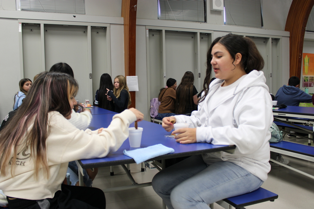 students enjoying cookies and hot chocolate 