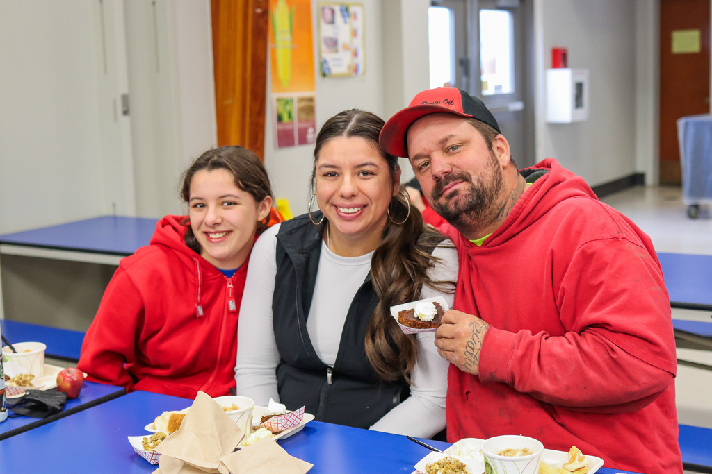 photo of student with family at Thanksgiving Feast 