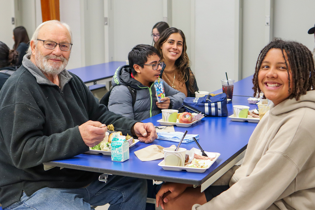 Photo of student with family at Thanksgiving Feast 