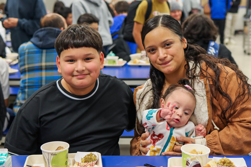 photo of student with family at Thanksgiving Feast 