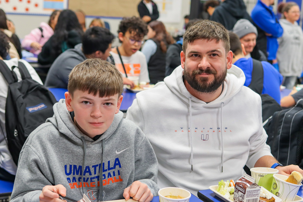 photo of student with family at Thanksgiving Feast 
