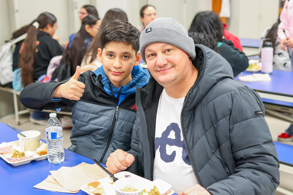 photo of student with family at Thanksgiving Feast 