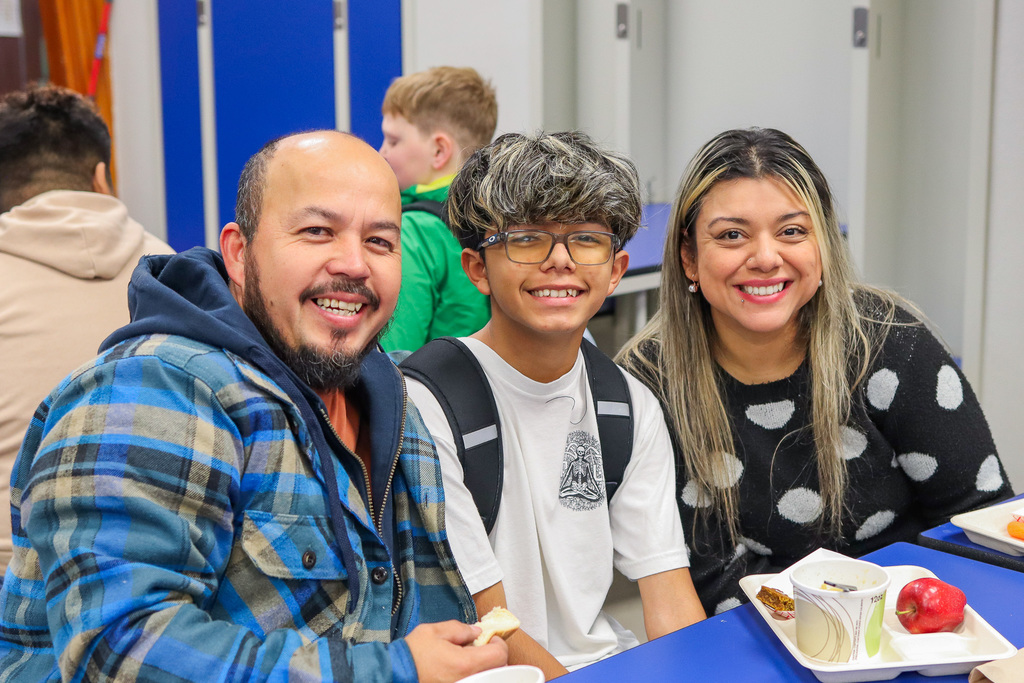 photo of student with family at Thanksgiving Feast 