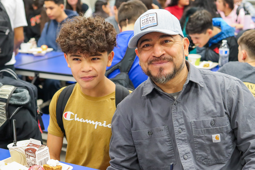 photo of student with family at Thanksgiving Feast 