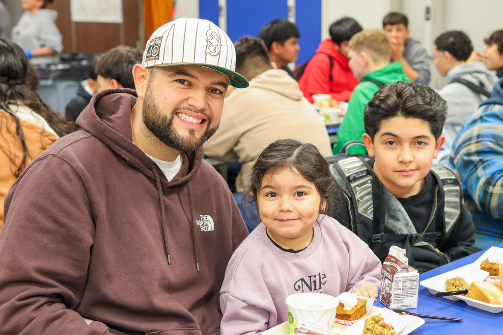 photo of student with family at Thanksgiving Feast 