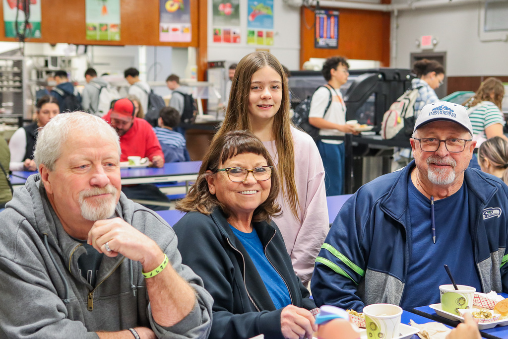 photo of student with family at Thanksgiving Feast 