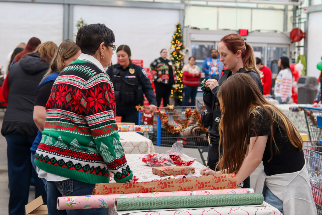 student and Walmart staff wrapping gifts 