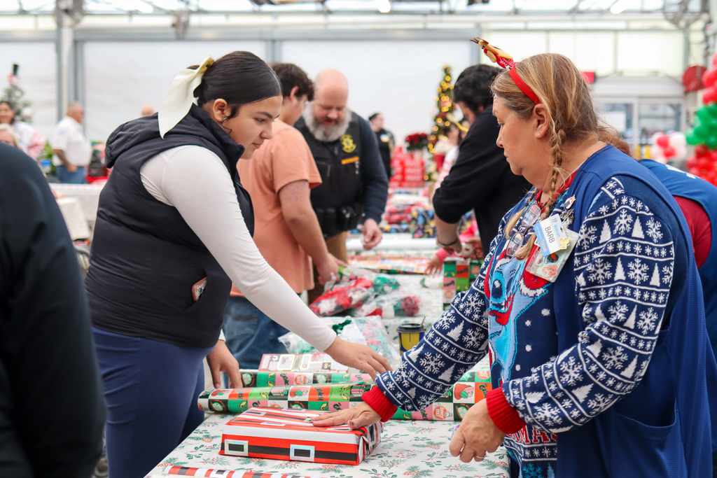 student and Walmart staff wrapping gifts 