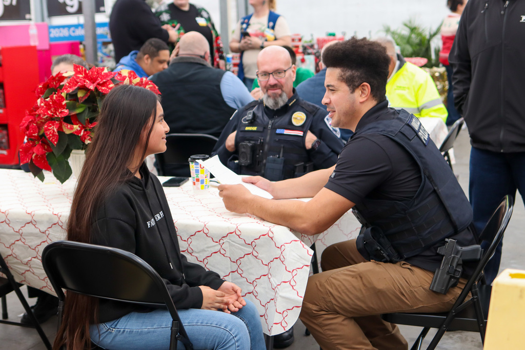 police officer and student going over shopping list 