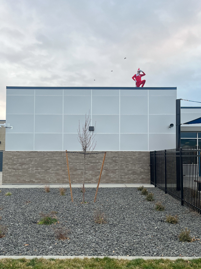 The Elf on the Shelf on top of the school 