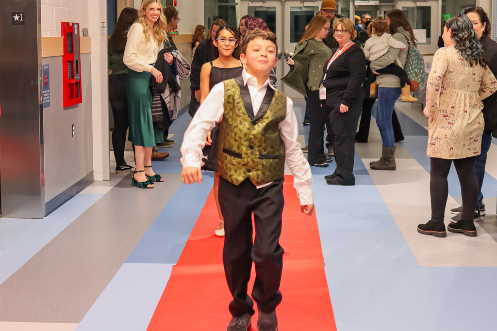 student taking a photo on the red carpet 