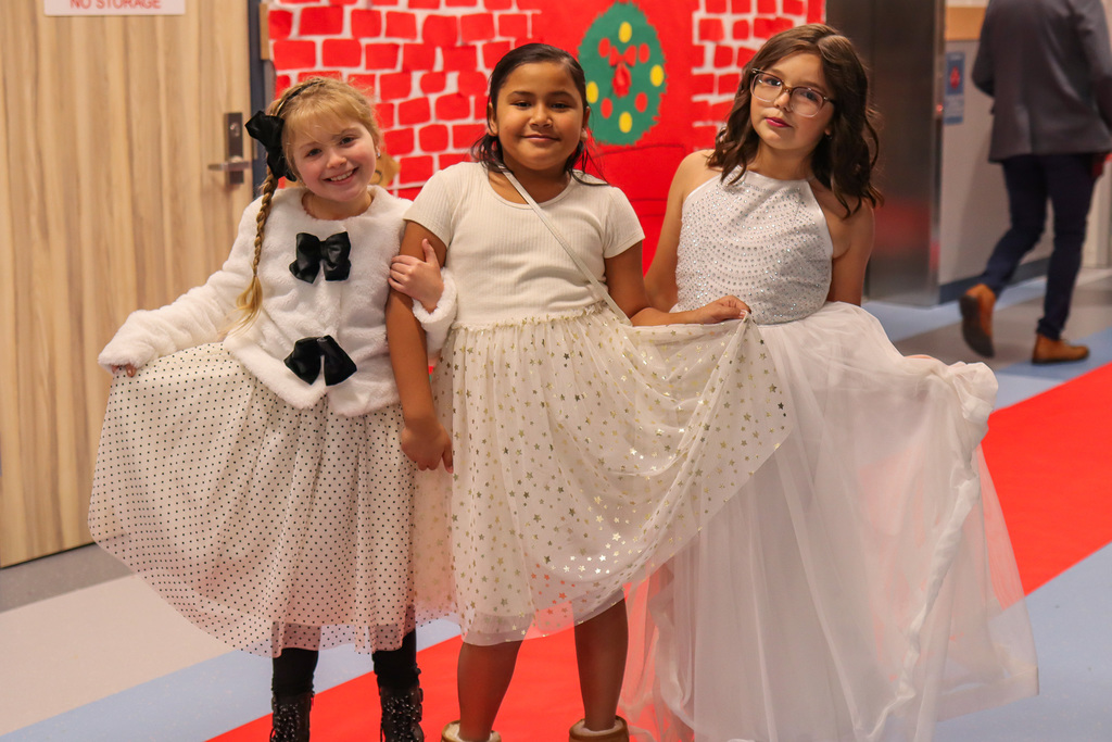 Students taking a photo on the red carpet 